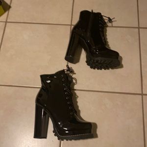 Women’s shiny leather black heel boots.